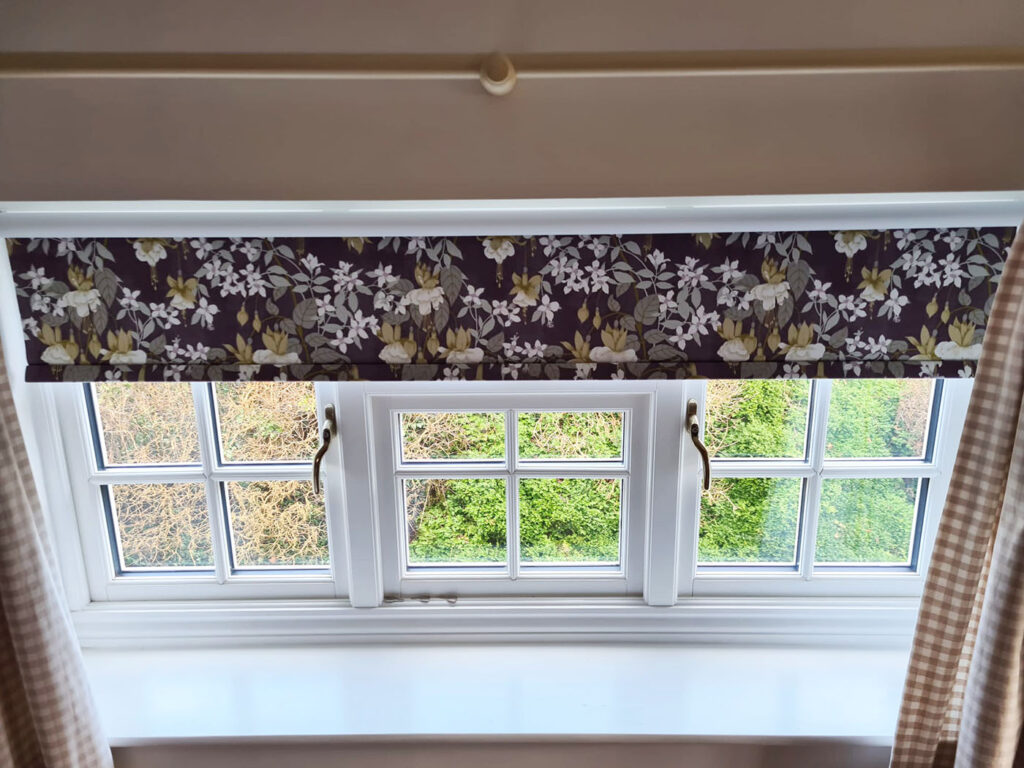 Local Blinds Transformations - Recent Projects in Northamptonshire - this image shows a floral patterned roller blkind installed in a bedroom in Northamptonshire
