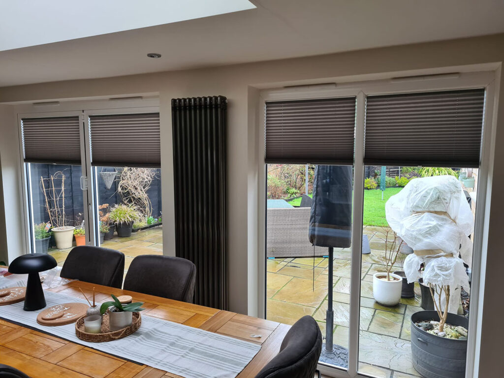 Local Blinds Transformations - Recent Projects in Northamptonshire - this image shows dark grey pleated blinds installed in a dining room in Northamptonshire
