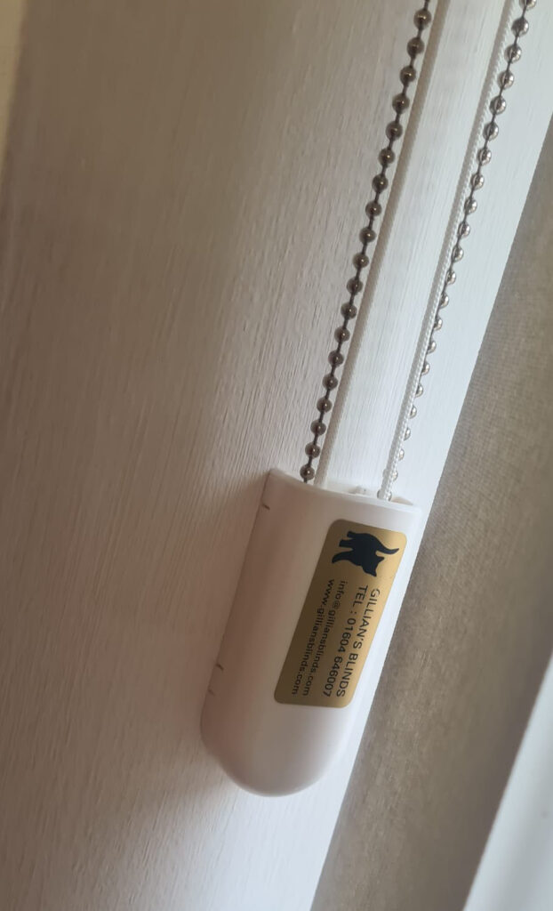 Vertical Blinds by Gillians Blinds this image shows the safety mechanism with Gillian's Blinds breanding and contact details
