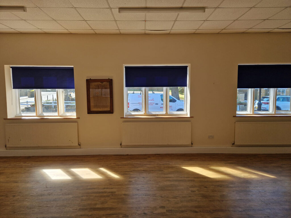 Beautiful New Blinds for Northamptonshire Village Hall this image shows 3x windows all fitted with the new deep blue roller blinds