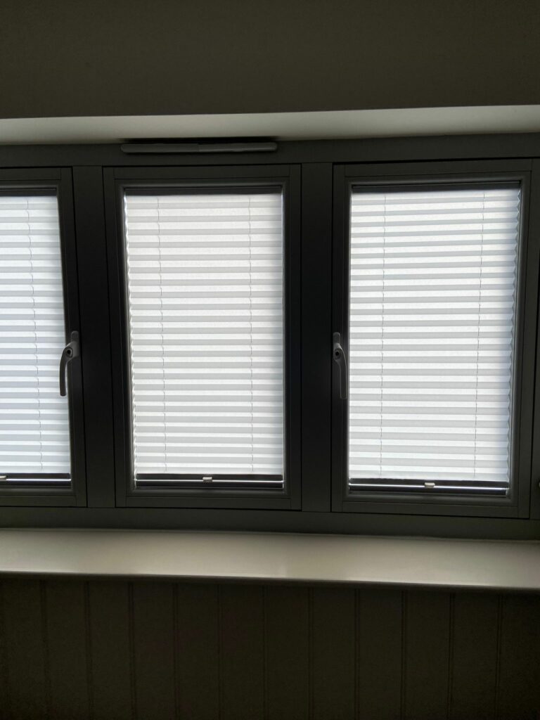 Close up of pleated blinds fitted inside window frame Bugbrooke home