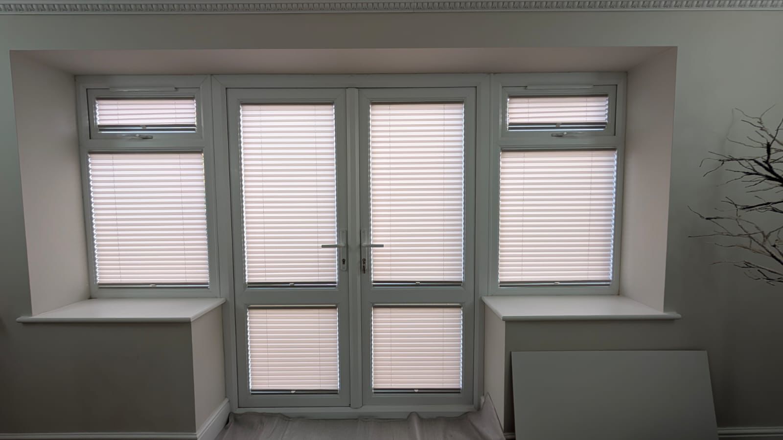 Pleated blinds fitted within bifold doors and side windows in Northamptonshire, providing privacy and light control while maintaining a clean, modern look