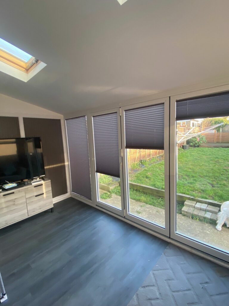 Pleated blinds fitted to bifold doors in Kingsthorpe Northampton allowing flexible light control and privacy in a modern living space