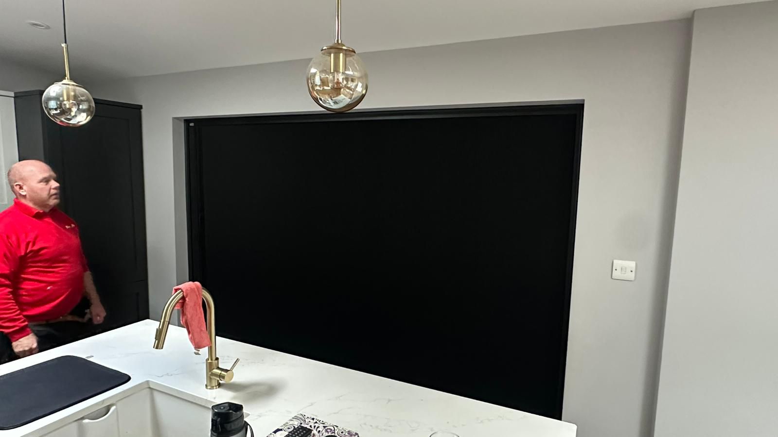Black blind screen system installed across large glazed kitchen doors in Market Harborough, creating modern shading, privacy and integrated fly screen functionality.