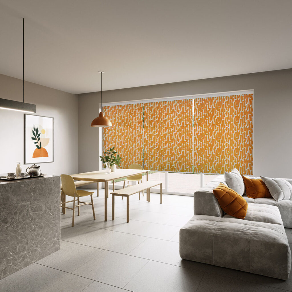 Orange patterned roller blinds fitted across extra-wide windows in a modern open-plan living space