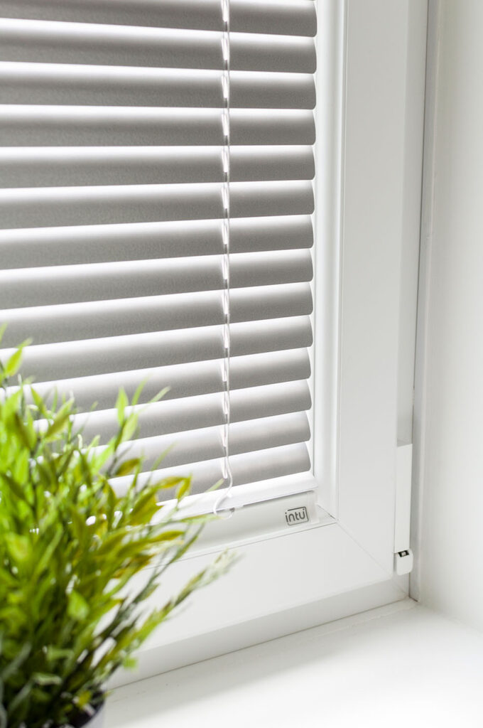 White Intu Venetian blind fitted neatly within a white window frame