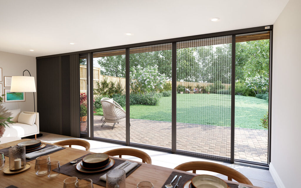 Blind screen fitted across extra-wide sliding patio doors overlooking a garden