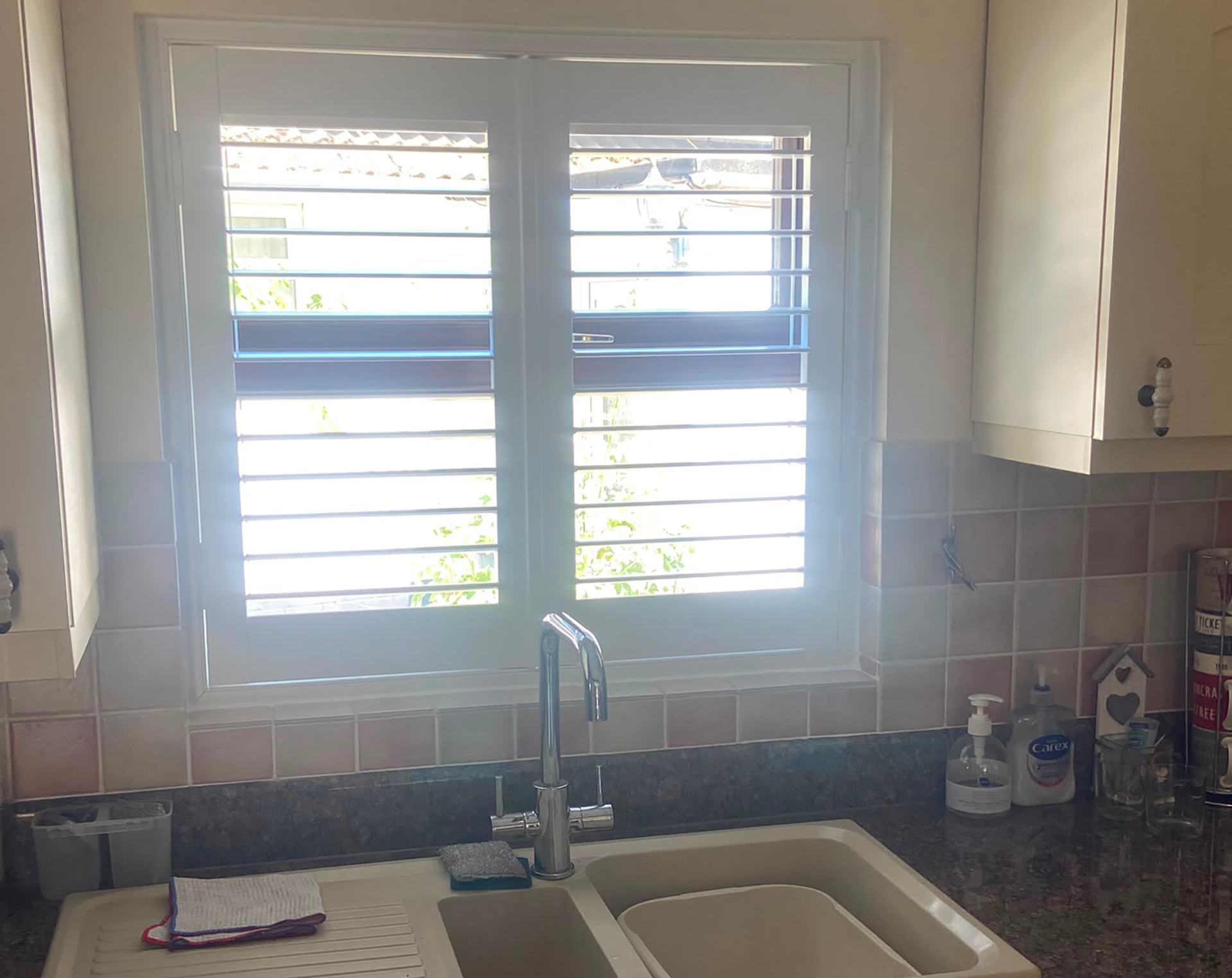 1. UPVC kitchen shutters fitted behind a sink in Brackley