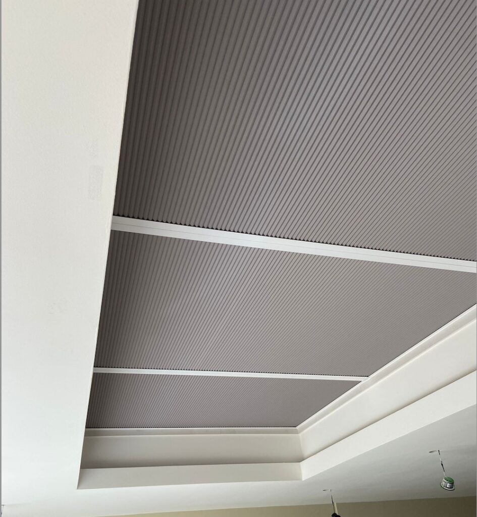 Grey pleated blinds closed across a large roof lantern in Rugby