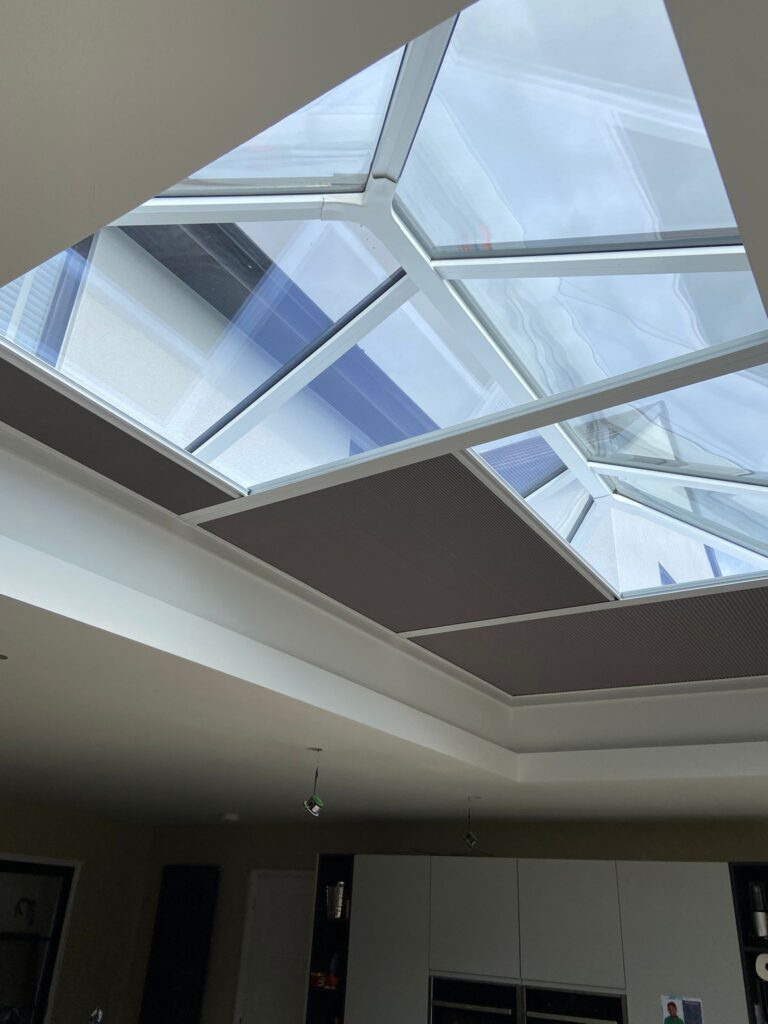 Specialist pleated roof blinds partly open beneath a glazed roof lantern in Rugby