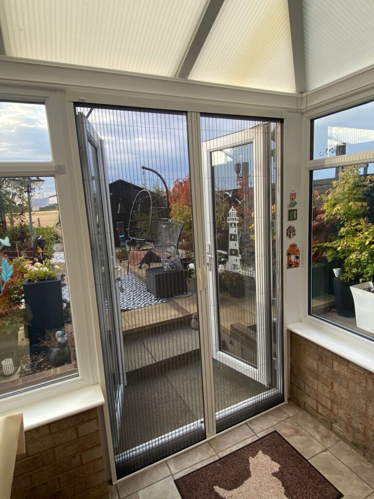 Retractable fly screen fitted across a conservatory door in Northampton
