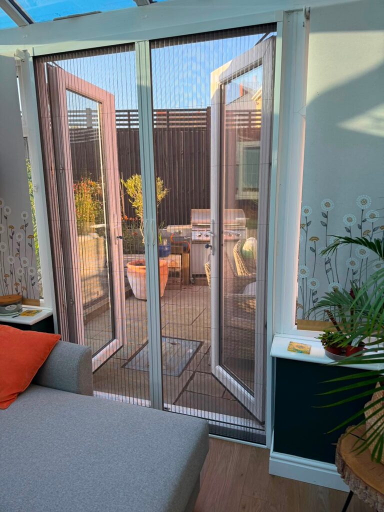 Centre-closing fly screen fitted across double garden doors in Wollaston