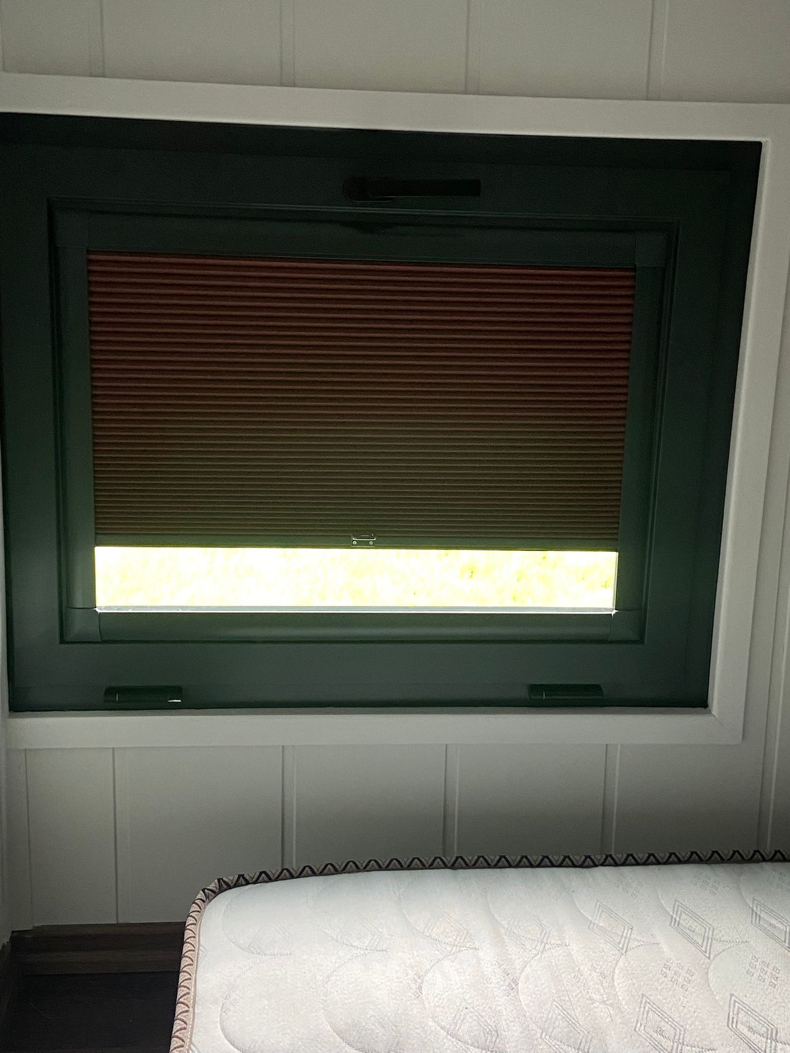 Partially open pleated blind providing privacy and light control