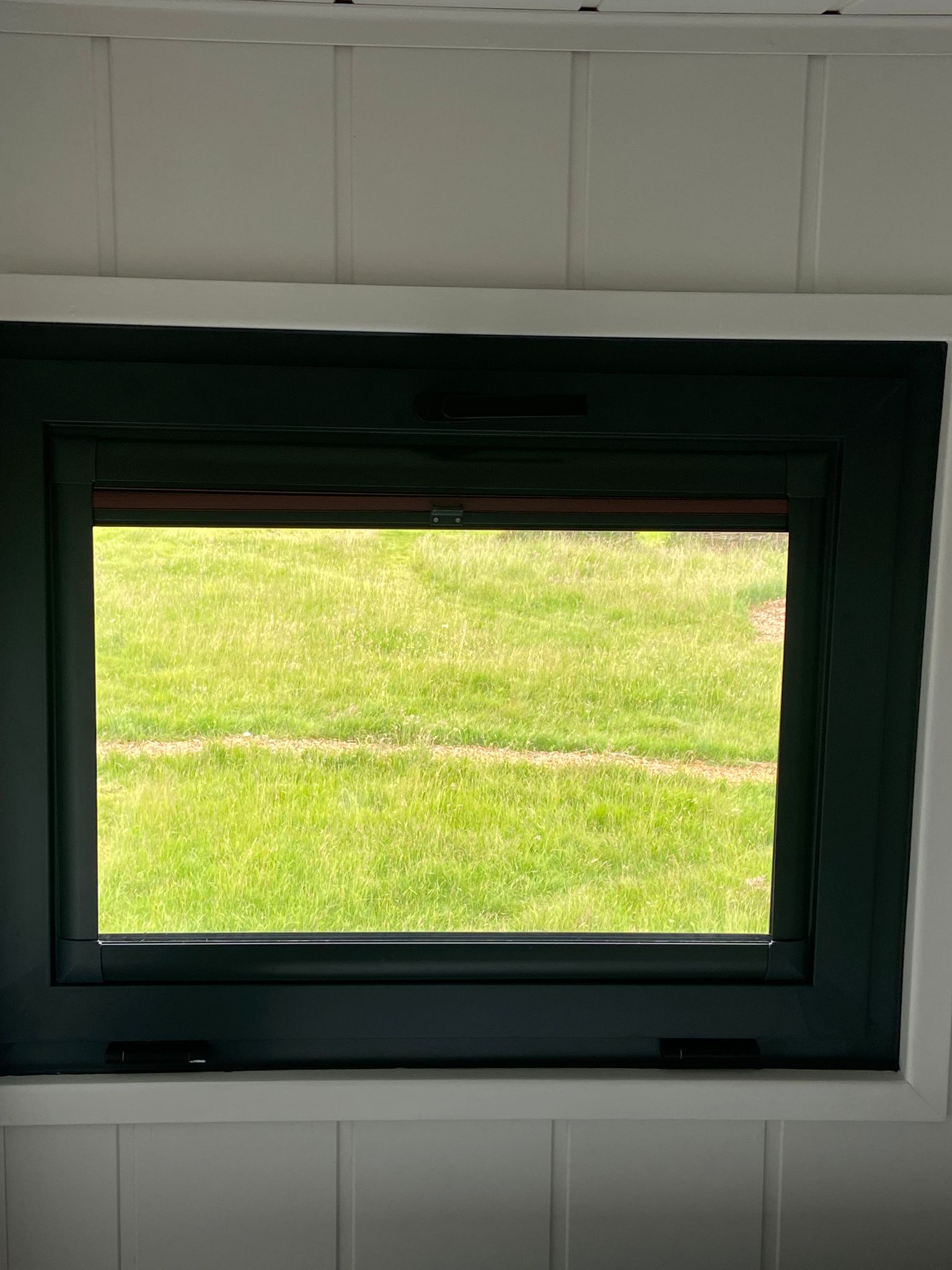 Open Perfect Fit pleated blind allowing natural light into trailer conversion