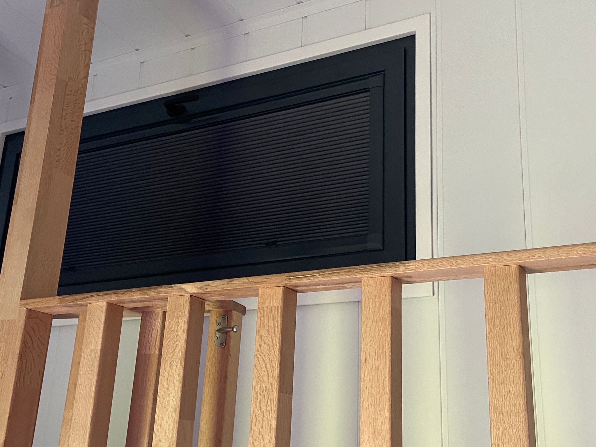 Closed pleated blind fitted to upper window in trailer conversion